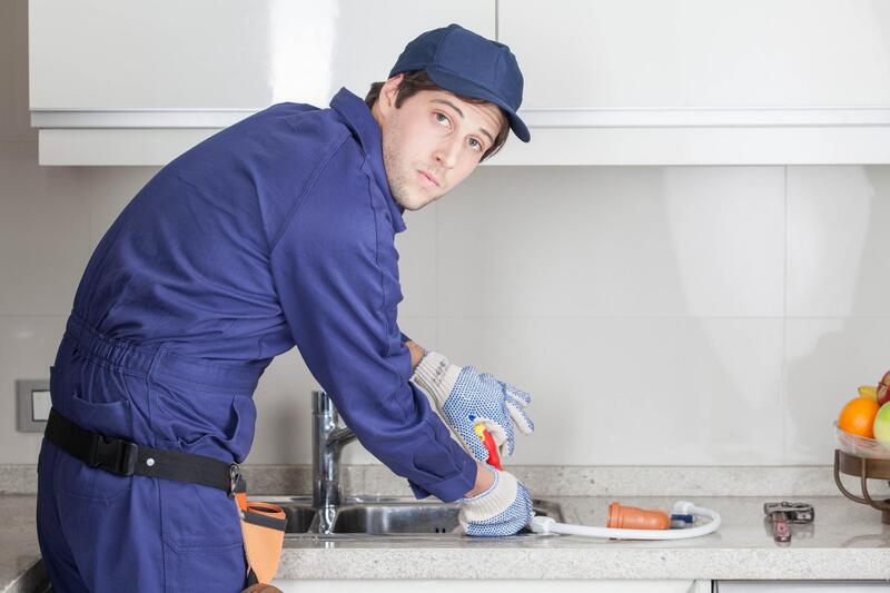 male worker fixing the kitchen sink